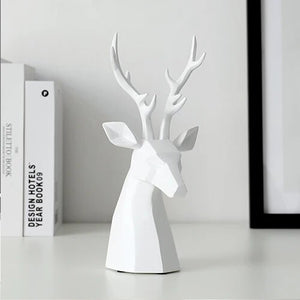 This beautiful Deer Head Bust sculpture is made of resin and comes available in 4 colors of black, white, gray and teal.  Measuring 26cm or 10 inches in height and 11.5cm or 4.5 inches in width. This figurine spots a contemporary design with sculptural form inspired by Origami. This decorative piece will add timeless elegance to your space year-round. Perfect for festive tablescapes, mantels and shelves.  This is a deer head bust in White.