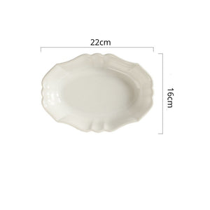 French Style Ruffle Edge Dish by Allthingscurated are oval shallow serving dishes featuring a ruffle edge with curved rims. Come in 3 colors of white, green and brown and in 2 sizes.  This is a large white dish measuring 22cm or 8.6 inches wide and 16cm or 6 inches in height.