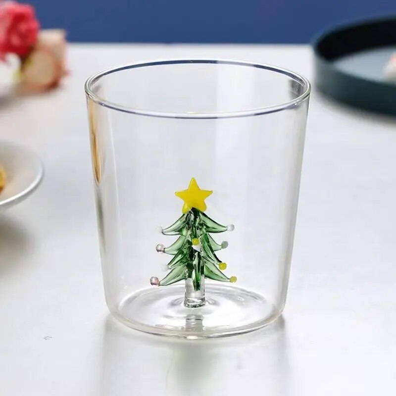 Christmas Tree Drinking Glass by Allthingscurated has a playful and whimsical design, featuring a sculptural 3D Christmas Tree within the tumbler. The tree comes in a 2 colors, green and white. Measuring 8.5cm or 3.3 inches in width at the top, 9cm or 3.5 inches in height and 6.5cm or 2.5 inches in width at the base, the drinking glass has a capacity of 300ml or 10 ounce. Featured here is one with a green Christmas tree.