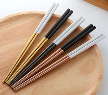 Load image into Gallery viewer, These Chinese chopsticks by Allthingscurated is contemporary with a square design for better food gripping. Made of 304 food grade stainless steel, they come in 6 different color combinations of Black and Gold, Black and Rose Gold, Black and Silver, White and Black, White and Gold, White and Rose Gold. Retailed as a set of 6 pairs, choose from one of the above color combinations or opt for an assorted set of 6 different color combinations. Chopstick length is 23.5cm or 9 inches.
