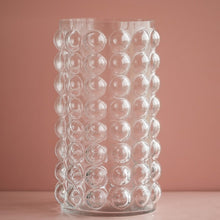 Load image into Gallery viewer, Zayla Bubble Vase by Allthingscurated features a geometric bubble design. The eye-catching detail and design are enough to make it a statement centerpiece with or without floral display. Comes in black or clear and in 2 sizes. The short vase measures 17cm or 6.6 inches in height and 16cm or 6.2 inches in diameter.  The tall vase measures 27.5cm or 10.7 inches in height and 13cm or 5 inches in diameter. This is a pair of clear vases with small pink flowers in the tall vase. This is a tall clear vase.
