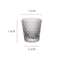 Load image into Gallery viewer, Carven geometric glass tumblers by Allthingscurated spots a unique design resembling the exterior of a pineapple.  An elegant and charming drinkware for serving cocktails, whiskey and sangria to you guests. Come available in clear or iridescent glass with height measuring 7.6cm or 3 inches by top diameter of 7.3cm or 2.8 inches and base diameter of 5.2cm or 2 inches.  This is a clear tumblier.
