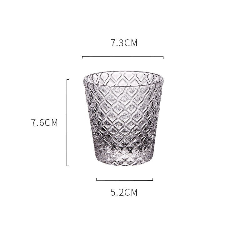 Carven geometric glass tumblers by Allthingscurated spots a unique design resembling the exterior of a pineapple.  An elegant and charming drinkware for serving cocktails, whiskey and sangria to you guests. Come available in clear or iridescent glass with height measuring 7.6cm or 3 inches by top diameter of 7.3cm or 2.8 inches and base diameter of 5.2cm or 2 inches.  This is a clear tumblier.