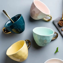 Load image into Gallery viewer, Allthingscurated colorful glazed porcelain cups with gold handle. Designed with a slight all-over concave effect surface that is unique. Available in pink, green, gray, yellow and teal with a capacity of 360ml or 12 ounce.
