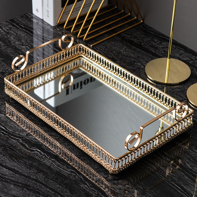 Donatella Mirror tray by Allthingscurated features a mirror surface and intricate gold-gilded pattern surround all sides of the rectangle tray and with 2 handles. Available in small, medium and large size. Featuring here is a large rectange tray.