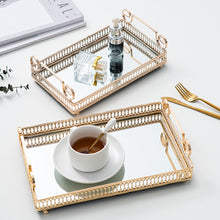 Load image into Gallery viewer, Donatella Mirror tray by Allthingscurated features a mirror surface and intricate gold-gilded pattern surround all sides of the rectangle tray and with 2 handles. Available in small, medium and large size. Featured here are two trays. One tray is with perfume bottles and another tray being used to serve a cup of coffee.
