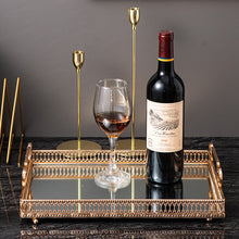 Load image into Gallery viewer, Donatella Mirror tray by Allthingscurated features a mirror surface and intricate gold-gilded pattern surround all sides of the rectangle tray and with 2 handles. Available in small, medium and large size.  Featured here is a large tray wit h a bottle of red wine and a red wine glass.

