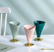 Load image into Gallery viewer, Allthingscurated dessert cup in the shape of an ice cream cone, measuring height 15.2cm and diameter 9.4cm, and included in the collection is a footed dessert bowl measuring height 7.5cm and diameter 12.3cm. Both designs made of glazed porcelain in light green, dark green and pink.
