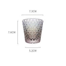 Load image into Gallery viewer, Carven geometric glass tumblers by Allthingscurated spots a unique design resembling the exterior of a pineapple.  An elegant and charming drinkware for serving cocktails, whiskey and sangria to you guests. Come available in clear or iridescent glass with height measuring 7.6cm or 3 inches by top diameter of 7.3cm or 2.8 inches and base diameter of 5.2cm or 2 inches.  This is an iridescent tumbler.
