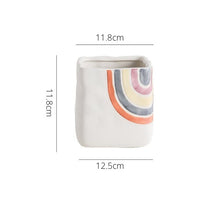Load image into Gallery viewer, Biba Ceramic Square Planter by Allthingscurated features hand-painted rainbow-like pattern on a creamy white background with a groovy and hippie vibe. Available in small, medium and large size. This is a medium pot measuring 11.8cm by 11.8cm or 4.6 inches by 4.6 inches.
