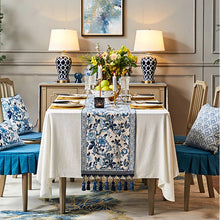 Load image into Gallery viewer, Porcelain Blue Table Runner by Allthingscurated features detailed designs of florals and birds in blue and printed on white background, inspired by the ancient Chinese Porcelain.  A fusion of the east and west— this CHINOISERIE style is contemporary, CHARMING and TIMELESS.  We added generous tassels in two shades of blues for a striking contrast. Made of cotton-linen blend with 6 sizes available.
