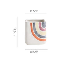 Load image into Gallery viewer, Biba Ceramic Square Planter by Allthingscurated features hand-painted rainbow-like pattern on a creamy white background with a groovy and hippie vibe. Available in small, medium and large size. This is a small pot measuring 11.5cm by 11.5cm or 4.5 inches by 4.5 inches.
