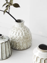 Load image into Gallery viewer, Kiara Stoneware Vases by Allthingscurated is a collection of small ceramic vases with a rustic beauty. Comes in various shapes and sizes with beautiful details and etched patterns. Off-white in color in 5 designs.
