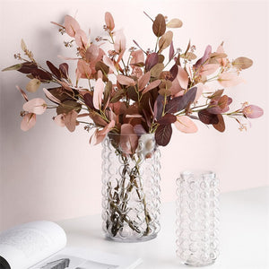 Zayla Bubble Vase by Allthingscurated features a geometric bubble design. The eye-catching detail and design are enough to make it a statement centerpiece with or without floral display. Comes in black or clear and in 2 sizes. The short vase measures 17cm or 6.6 inches in height and 16cm or 6.2 inches in diameter.  The tall vase measures 27.5cm or 10.7 inches in height and 13cm or 5 inches in diameter. Seen here is a pair of clear vases with autumn foliage.