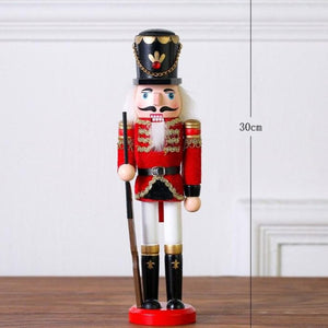 Christmas Nutcracker Toy Soldier Guard wearing  Red Uniform holding a rifle in his right hand. Standing at 30cm or 11.7 inches.