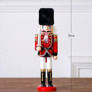 Christmas Nutcracker Toy Soldier Guard wearing Red Uniform holding a sword in his right hand. Standing at 30cm or 11.7 inches.