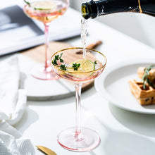 Load image into Gallery viewer, Allthingscurated Alaia Pink gold-rimmed champagne Coupe with a capacity of 140ml or 4.7 fluid ounce.  Made of lead-free crystal glass
