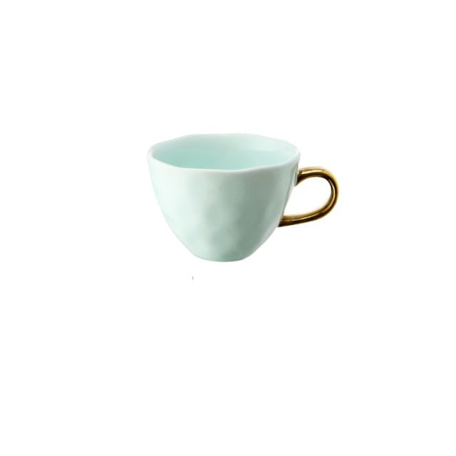 Allthingscurated glazed porcelain cup with gold handle in pastel green.  Designed with a slight all-over concave effect surface that is unique. Has a capacity of 360ml or 12 ounce.