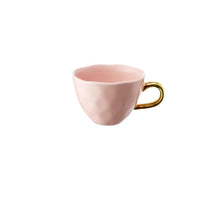 Load image into Gallery viewer, Allthingscurated glazed porcelain cup with gold handle in pastel pink. Designed with a slight all-over concave effect surface that is unique. Has a capacity of 360ml or 12 ounce.
