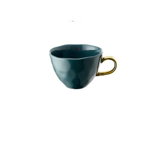 Allthingscurated  glazed porcelain cup with gold handle in Teal.  Designed with a slight all-over concave effect surface that is unique. Has a capacity of 360ml or 12 ounce.