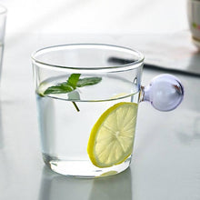 Load image into Gallery viewer, Drinking Glass with colored spherical handle in lilac, measuring 8.5 x 8.5 x 7cm or 3.3 x 3.3 x 3 inches with a capacity of 350ml or 11.8 ounce.
