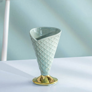 Allthingscurated dessert cup in the shape of an ice cream cone, measuring height 15.2cm and diameter 9.4cm. Made of glazed porcelain in light green.