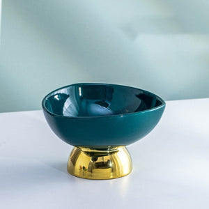 Allthingscurated footed dessert bowl measuring height 7.5cm and diameter 12.3cm.  Made of glazed porcelain in dark green.
